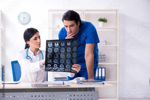 Two young doctors working in the clinic 