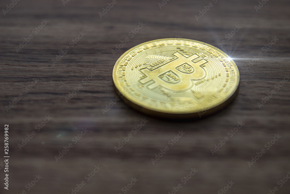 Bitcoin cryptocurrency coin on a wooden surface Bitcoin cryptocurrency coin on a wooden surface