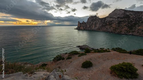 Seascape in sunset with fast flying clouds, time-lapse 4K video