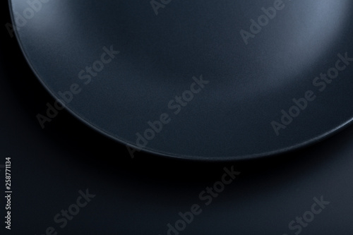 A plate on the table on the black background