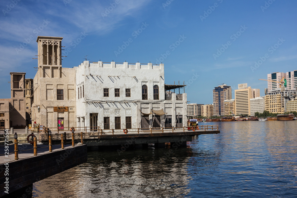 Dubai, UAE: Tourist boat abra on canal Dubai Creek and old town.