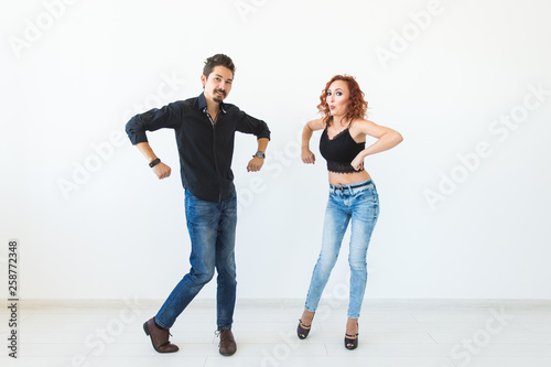 Social dance concept - Crazy dancing, cheerful couple over white background