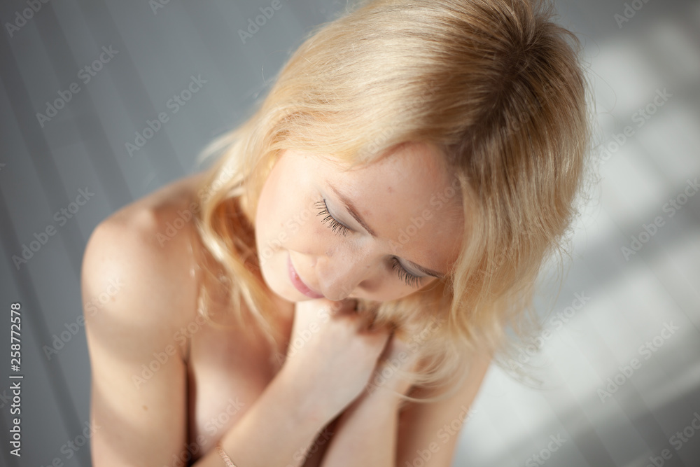 Fototapeta premium Attractive blond girl posing at the loft studio