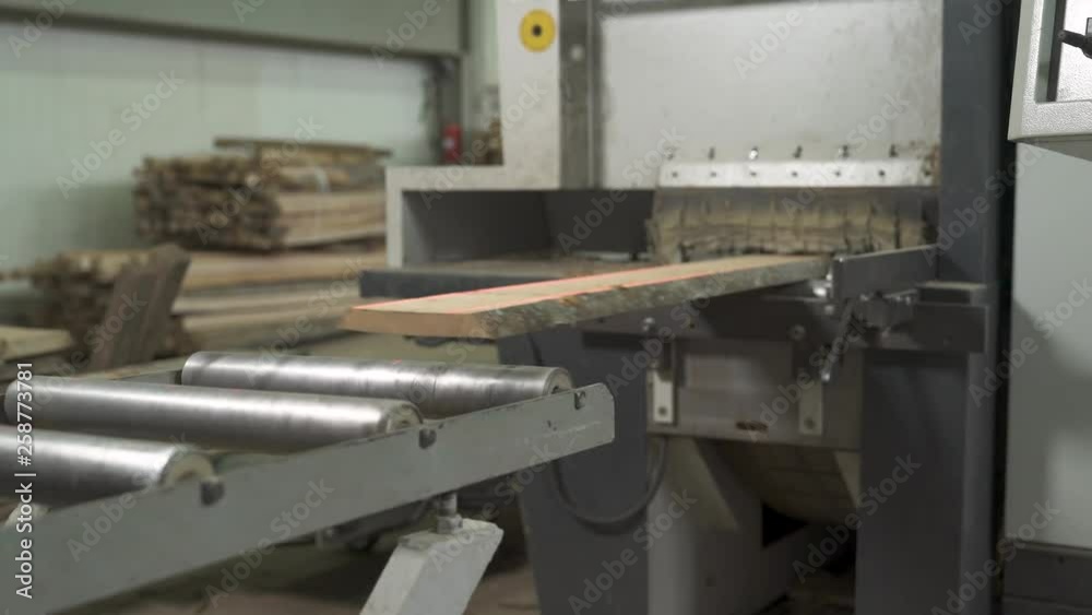 A close-up of a wooden workpiece moving on industrial conveyor belt A close-up of a wooden workpiece moving on industrial conveyor belt