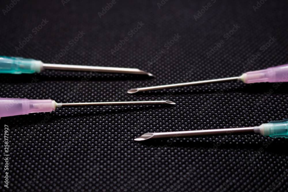 Cannula isolated on black background. Medical needle. Macro shot Cannula isolated on black background. Medical needle. Macro shot