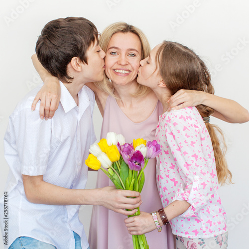 Daughter and son give mom flowers