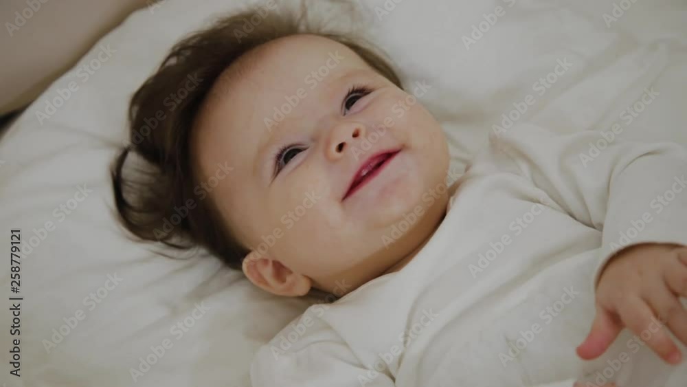 Beautiful little girl woke up and smiles at the camera Beautiful little girl woke up and smiles at the camera