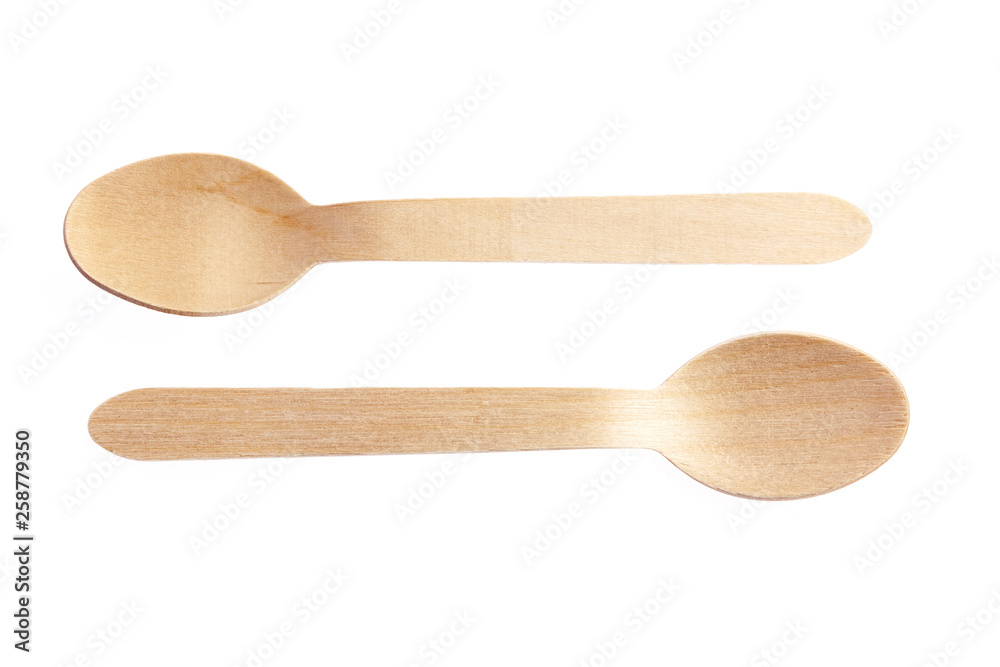 Eco-friendly materials. Wooden, disposable spoon on a white background. Eco-friendly materials. Wooden, disposable spoon on a white background.