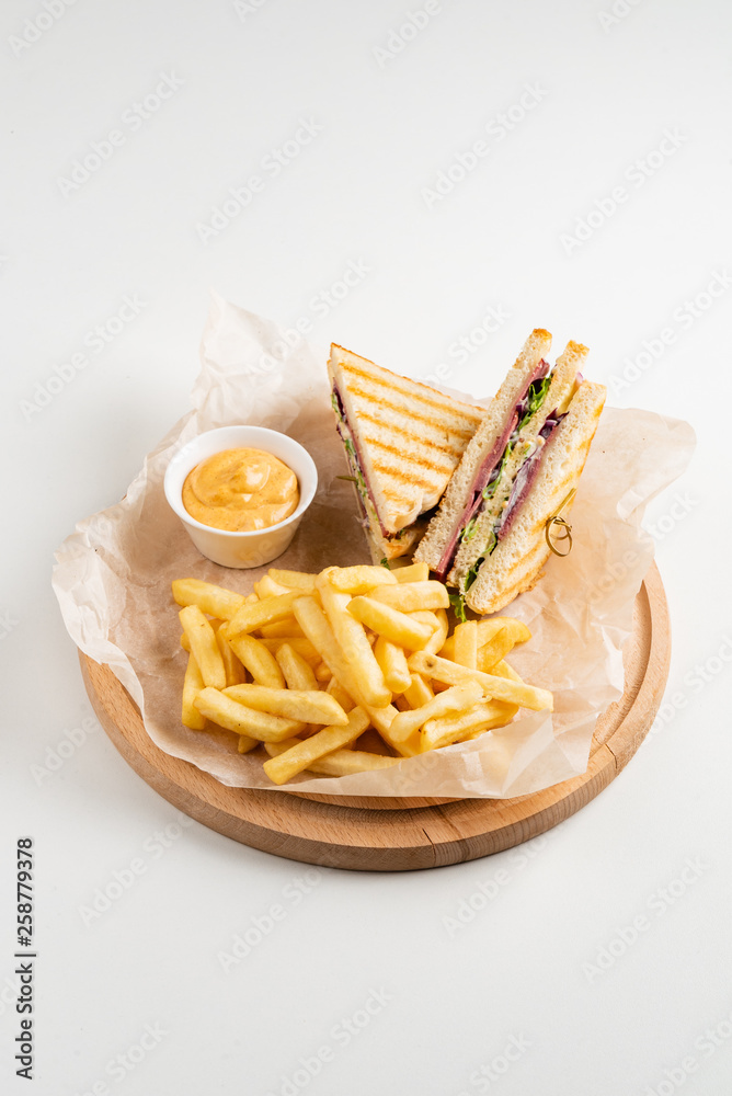 Club Sandwich with Cheese, PIckled Cucmber, Tomato and Smoked Meat. Garnished with French Fries Club Sandwich with Cheese, PIckled Cucmber, Tomato and Smoked Meat. Garnished with French Fries