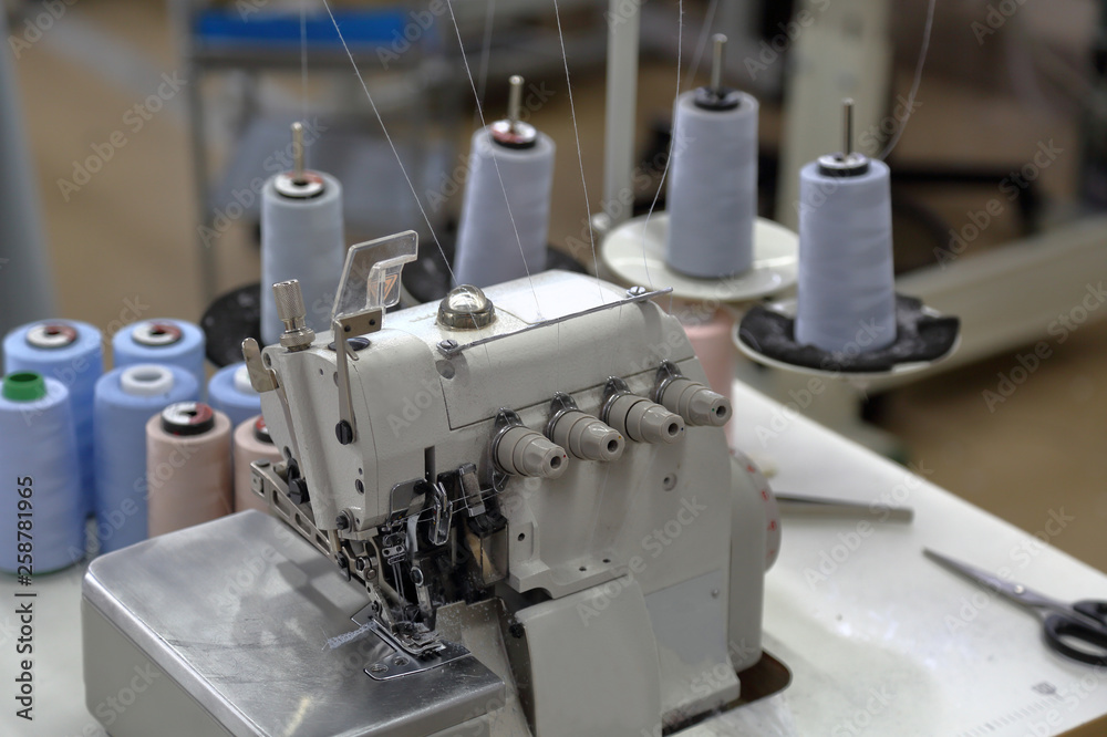 Fototapeta premium A small workshop for sewing clothes with professional equipment and tools