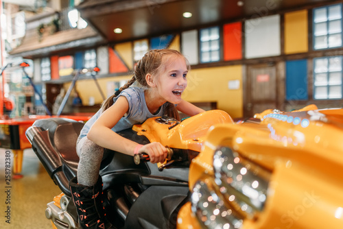 Girl plays game machine, entertainment center