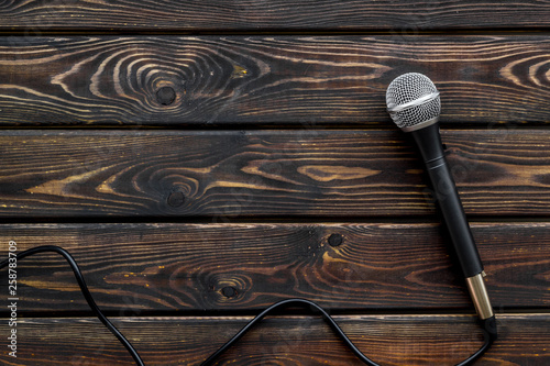 microphone for blogger, journalist or musician work on wooden background top view copyspace