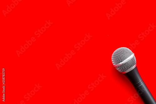 blogger, journalist or musician work space with microphone on red background top view space for text