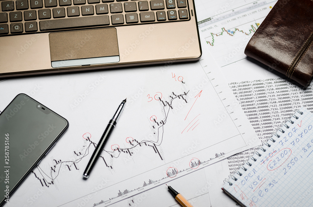 Forex charts on paper, notebook, financial notes in Notepad Forex charts on paper, notebook, financial notes in Notepad