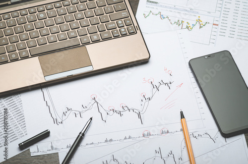 Forex charts, notebook, financial notes in Notepad