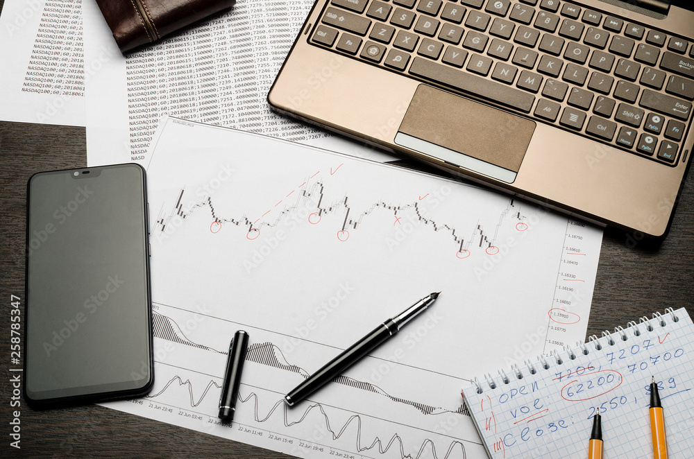 Financial charts of currencies on paper, profit analysis, financier's workplace Financial charts of currencies on paper, profit analysis, financier's workplace