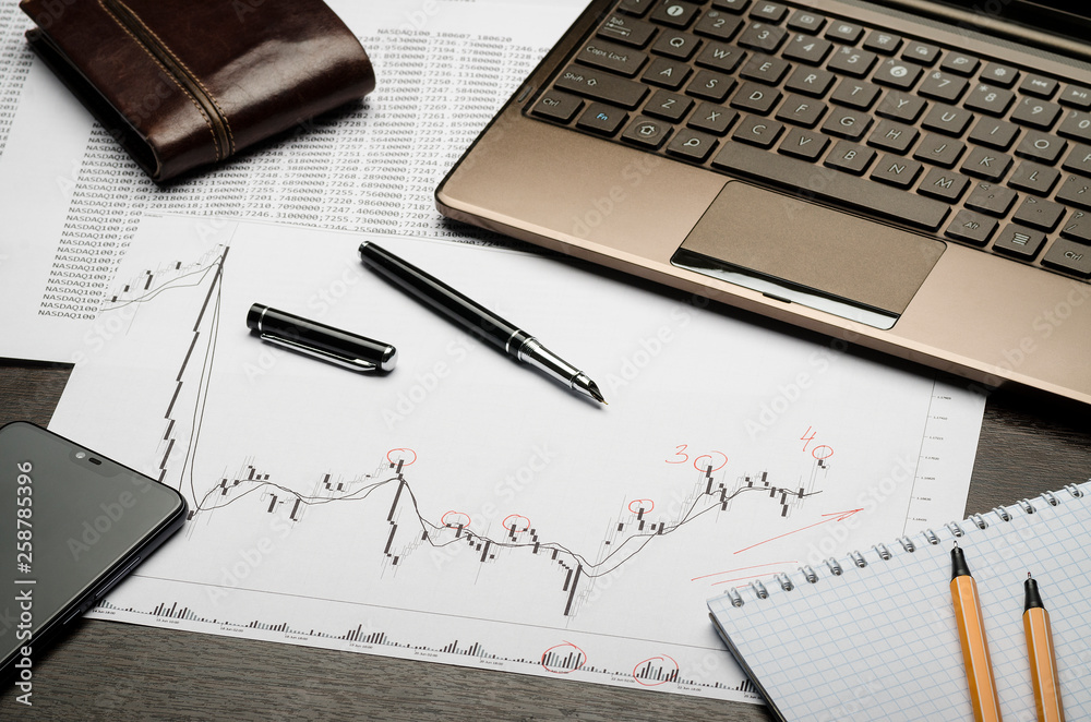 Financial charts and reports on paper, currency analysis, broker's workplace Financial charts and reports on paper, currency analysis, broker's workplace