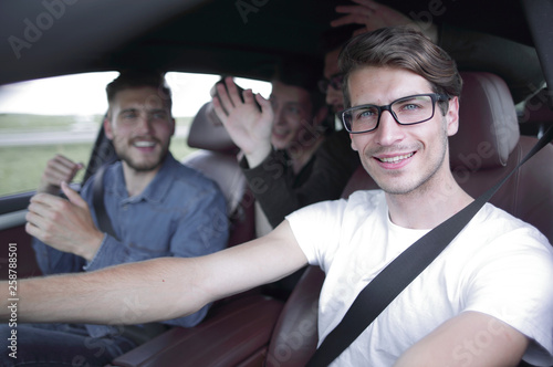 Close up side portrait of happy man driving car