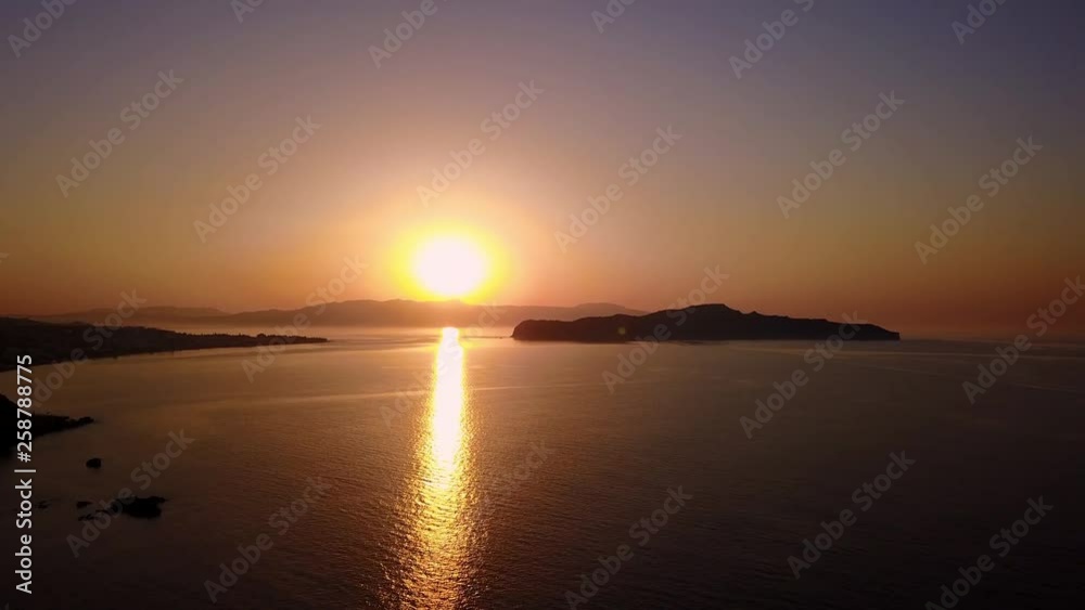 Aerial view of a the mediterranean sea in golden sunlight - flying towards the sun Aerial view of a the mediterranean sea in golden sunlight - flying towards the sun