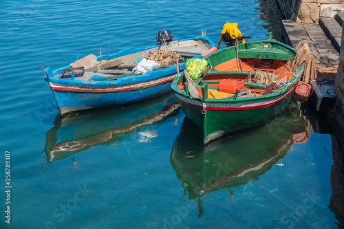 A colorful variety of boats and ships fill the docks of the harbors of Syracuse  Siracusa   a historic city on the island of Sicily  Italy.