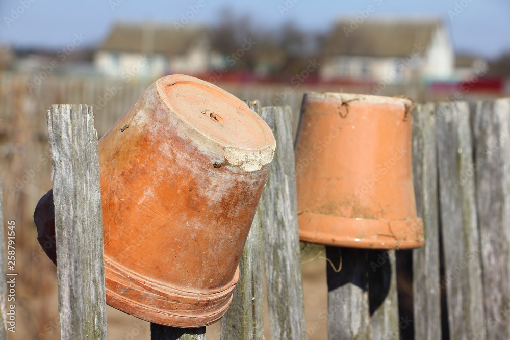 Clay pots on an old wooden fence, rustic landscape