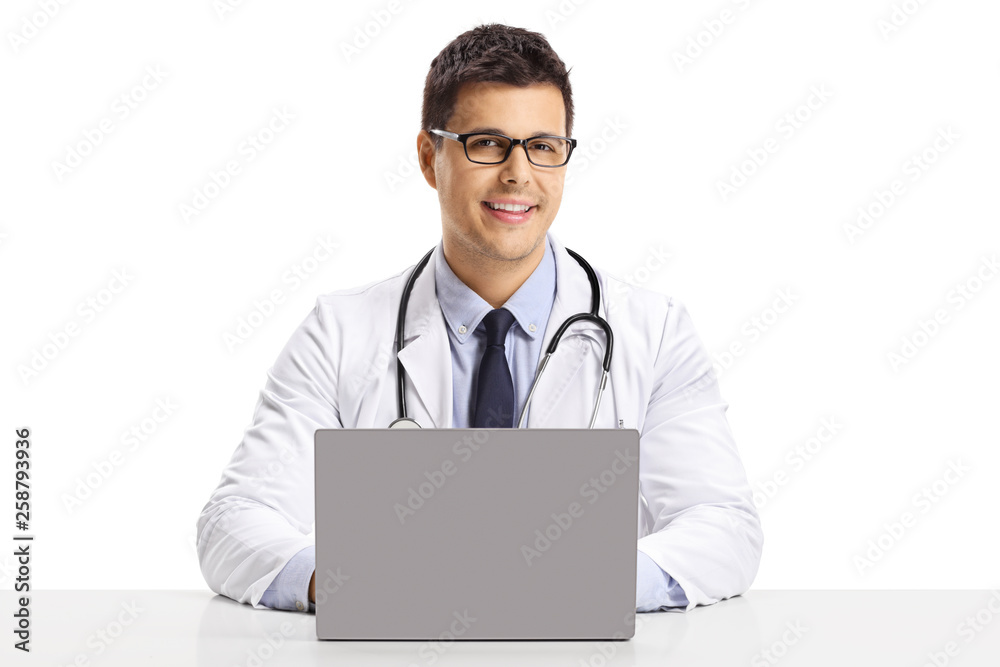 Male doctor sitting with a laptop and smiling Male doctor sitting with a laptop and smiling