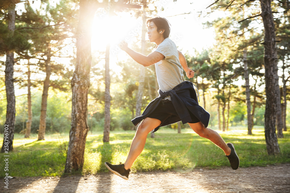 Full length of a confident asian athlete man running Full length of a confident asian athlete man running