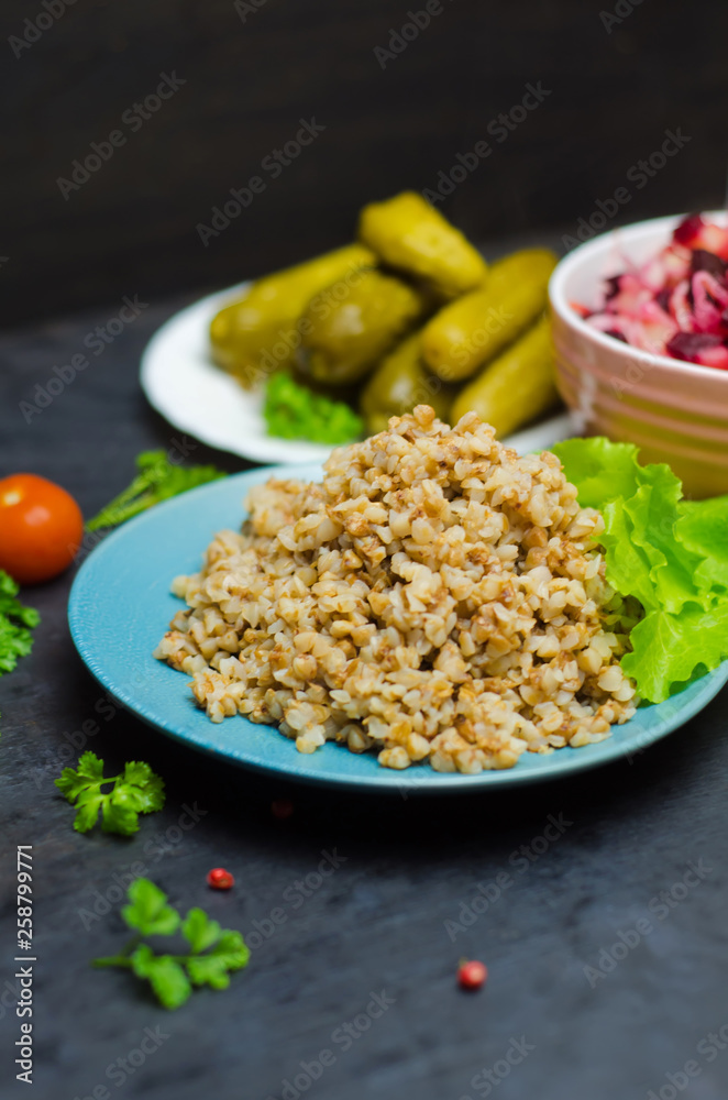 Russian buckwheat porridge near greens, proper nutrition, vegetarian