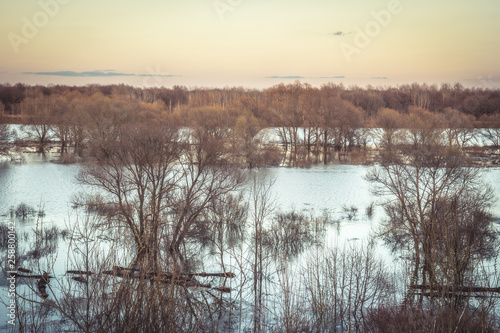 Spring flood rural countryside scenery landscape at flooded river with sunset sky photo