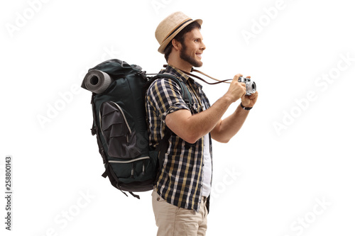 Young male tourist with a backpack and a camera