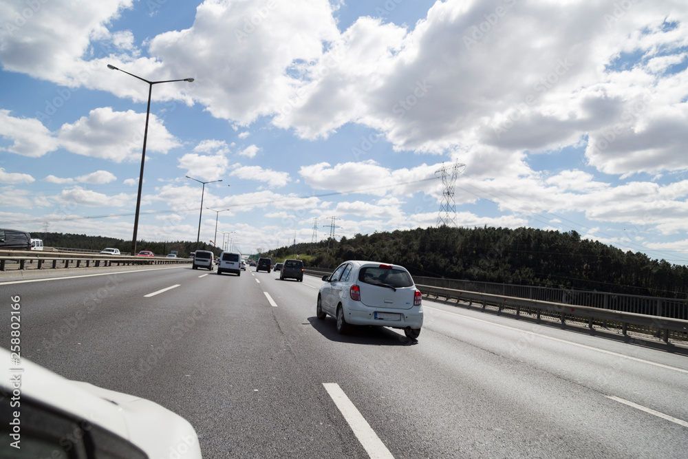 Fototapeta premium Cars on busy road driving in evening.