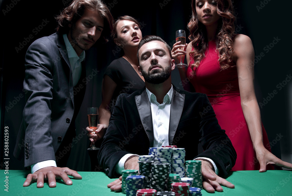 Attractive young caucasian man make bet in the casino Attractive young caucasian man make bet in the casino