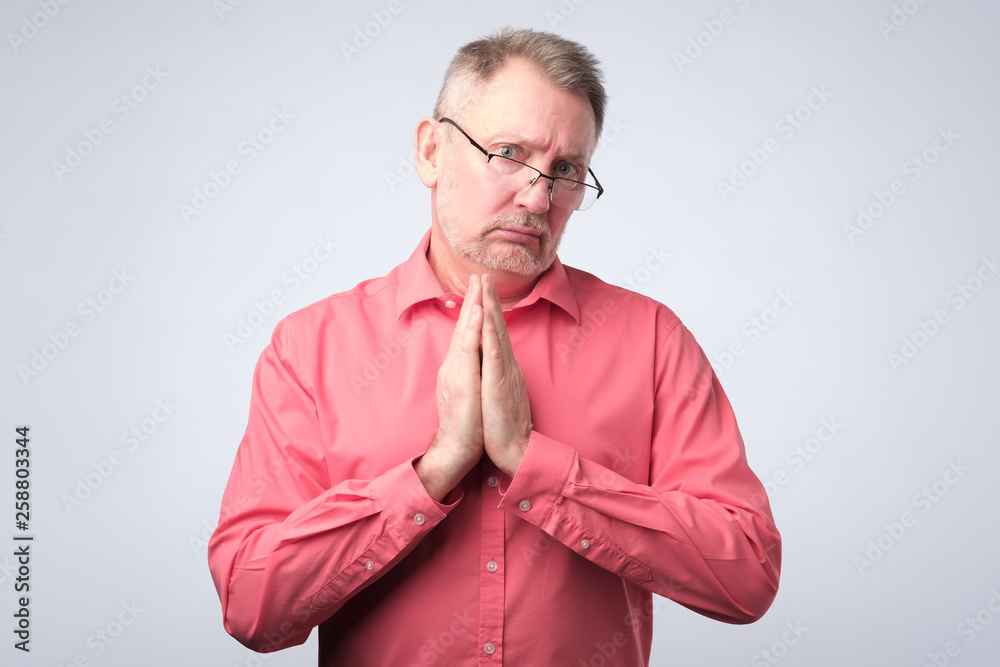 Senior man in red shirt need a help. Senior man in red shirt need a help.