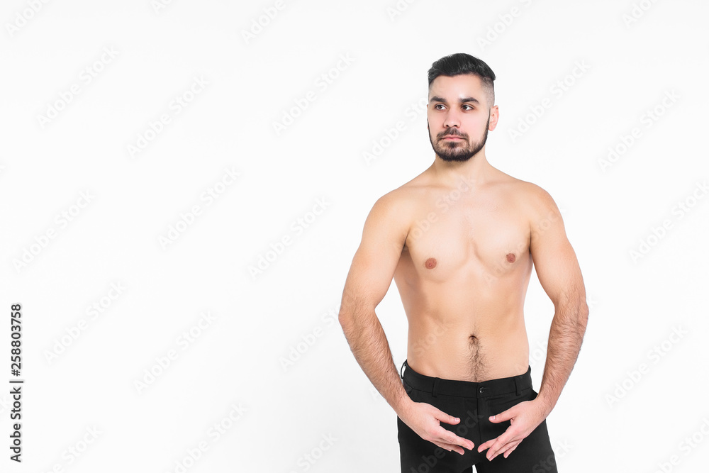 Young man athlet , isolated on the white background. Wearing at black pants with a bare torso. Young man athlet , isolated on the white background. Wearing at black pants with a bare torso.