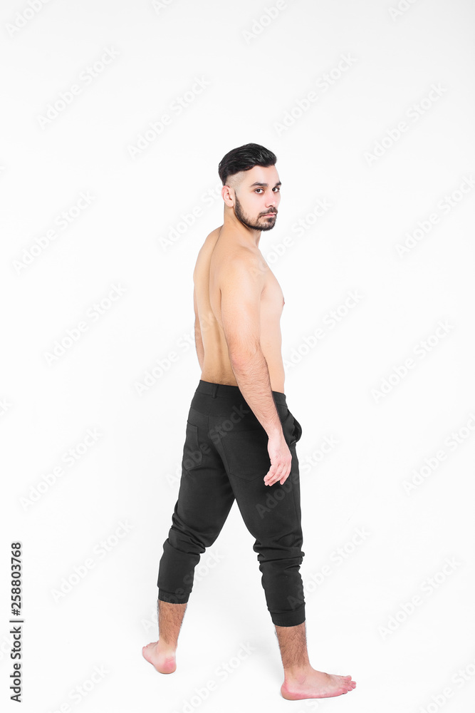 Fototapeta premium Stylish boy stay on back and looking to the camera, isolated on white!