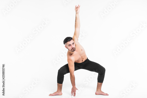 Handsome young ballet dancer on white background.