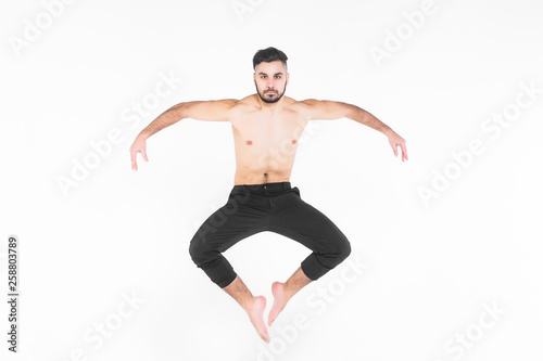 Young, acrobat man doing exercise  in the air isolated on white!