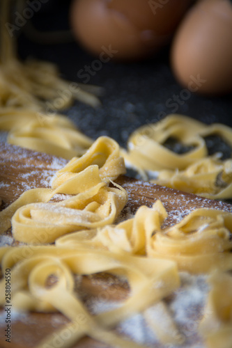 Still life homemade pasta. eggshells, flour on a dark table. close up