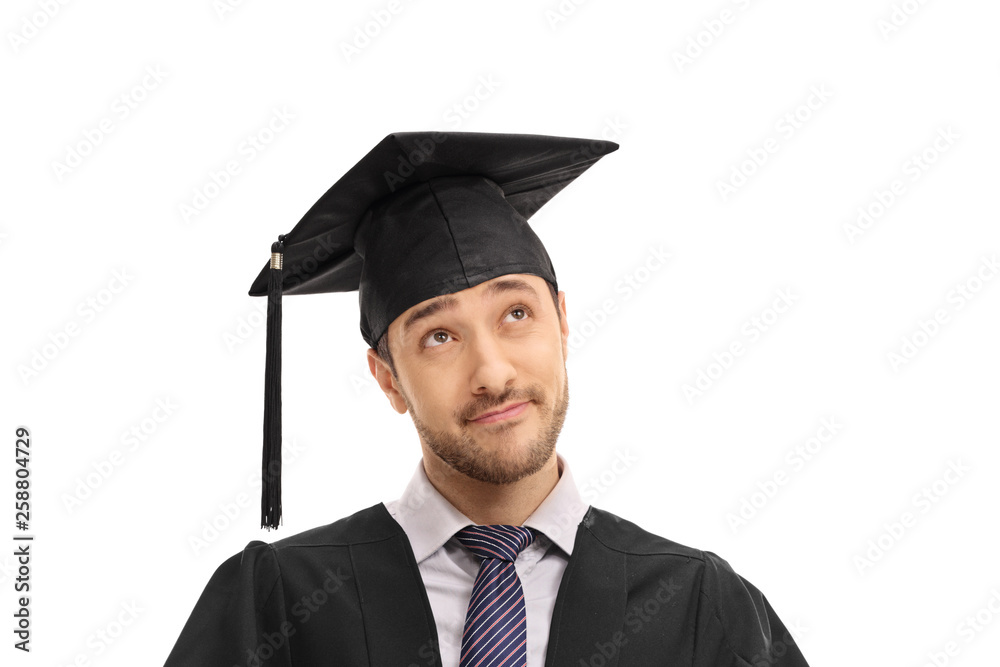 Pensive graduate male student in a gown Pensive graduate male student in a gown