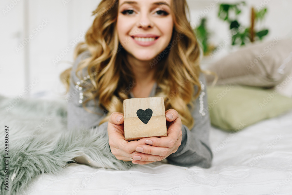 Beautiful young caucasian European woman holding a symbol for love. Heart. Beautiful young caucasian European woman holding a symbol for love. Heart.