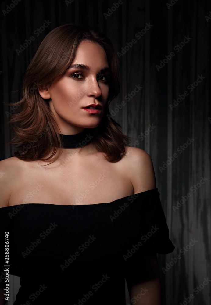 Mystic sexy makeup woman with red lipstick and short hairstyle looking passion on dark shadow background. Art