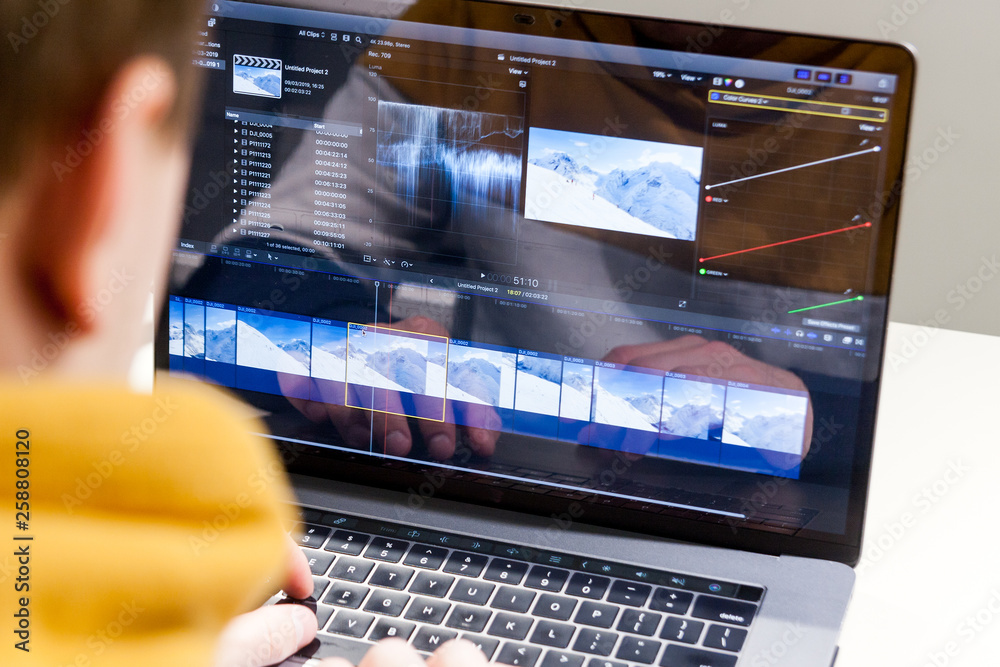 Video editing with laptop. Professional editor adding special effects