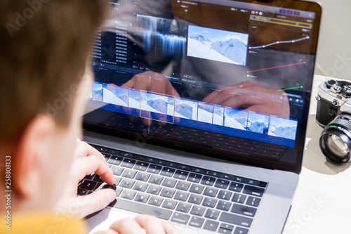 Video editing with laptop. Professional editor adding special effects or color grading footage for commercial film or movie.