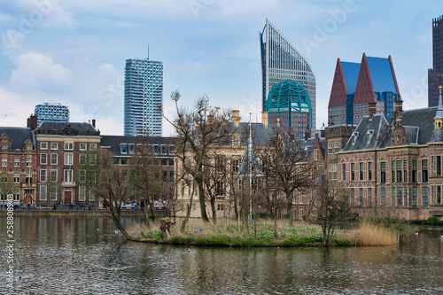 HAGUE  NETHERLANDS - APRIL 15  2018  Binnenhof Palace - Dutch Parlament in the Hague. Islet on the pond and view of the skyscrapers