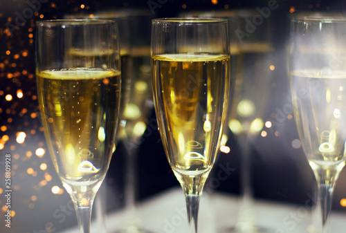 Glasses of champagne with festive background.