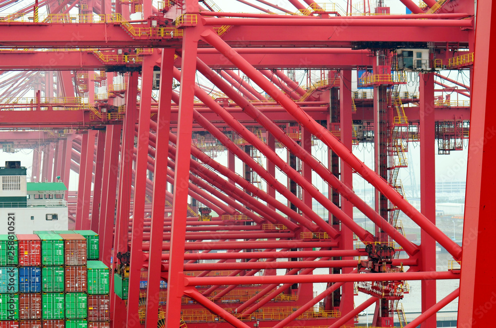 Gantry cranes over container ship, China. 