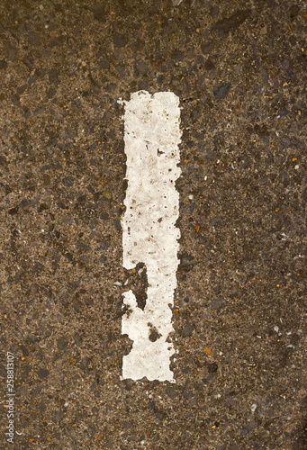 Detail of Crumbling White Painted Number One On Rough Concrete Ground