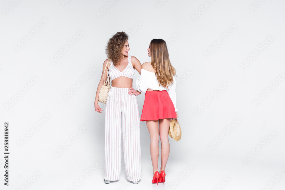 Two model woman in stylish trendy summer outfit. Young beautiful pretty lady in fashion pose. Lifestyle! Two model woman in stylish trendy summer outfit. Young beautiful pretty lady in fashion pose. Lifestyle!