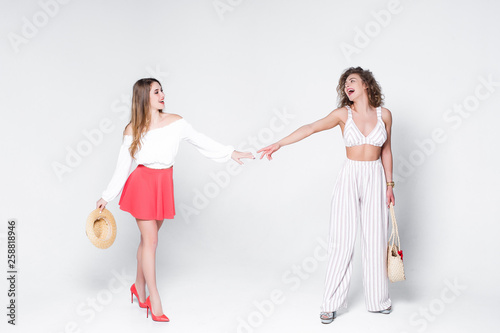 Friendsip! Beautifu woman walk together, while staying on white background!