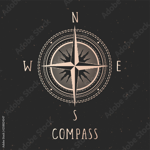 Vector illustration with gold compass or wind rose and frame on dark background.